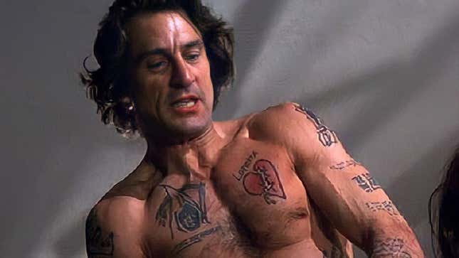 Robert DeNiro shirtless and covered in fake tattoos in Cape Fear.