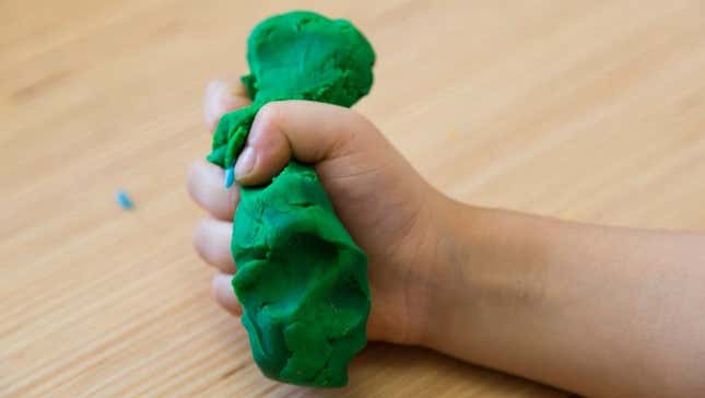 Child squeezing Play-Doh