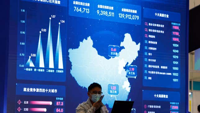 A man stands in front of a large screen showing analytics data about the Chinese web at an internet fair in Beijing in April 2021; used here as stock photo.