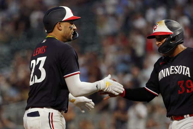 Jun 1, 2023; Minneapolis, Minnesota, USA; Minnesota Twins third baseman Royce Lewis celebrates his two-run home run against the Cleveland Guardians with designated hitter Donovan Solano (39) in the eighth inning at Target Field.
