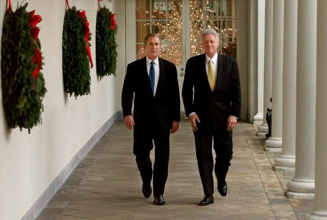 George W. Bush is escorted by US president Bill Clinton to the Oval Office in 2000.