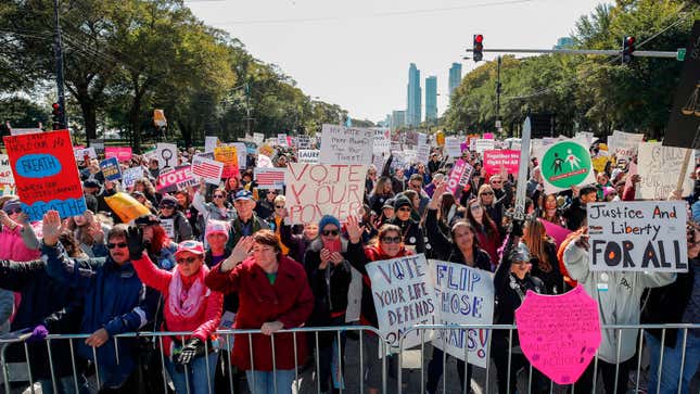 People hold signs during a rally and march in Chicago to inspire voter turnout ahead of the 2018 midterm polls.