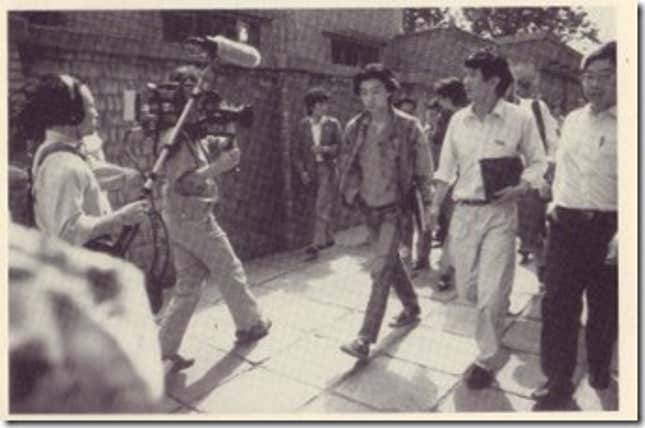Shen Tong approached by journalists. Tong helped organize negotiations between the government and the students.