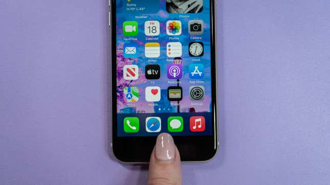 A photo of a thump touching the Home button