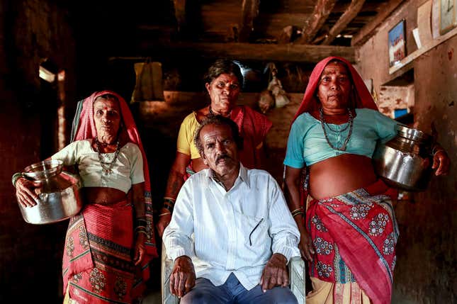 Sakharam Bhagat, 66, poses with his wives, Sakhri, Tuki and Bhaagi (L to R) inside their house