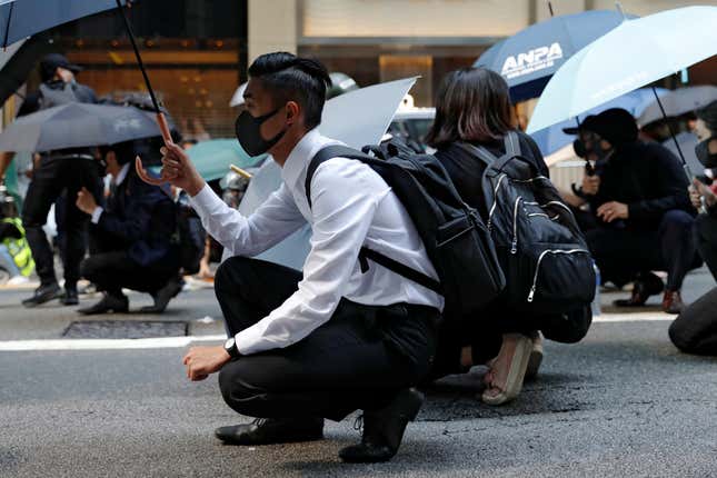 Office workers in the Central business district took part in a lunchtime protest where police fired multiple grounds of tear gas on Nov. 11, 2019.