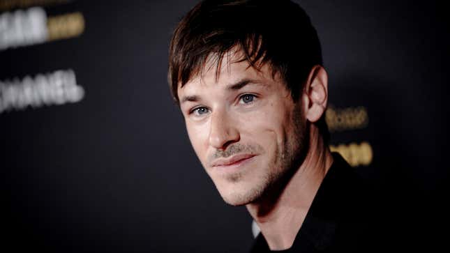 French actor Gaspard Ulliel, in a simple black long-sleeved shirt, smiles at the press.