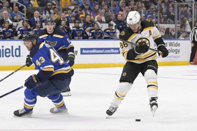 Apr 2, 2023; St. Louis, Missouri, USA; Boston Bruins right wing David Pastrnak (88) controls the puck from St. Louis Blues defenseman Calle Rosen (43) during the first period at Enterprise Center.