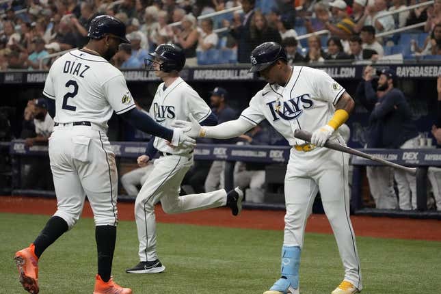 Apr 1, 2023; St. Petersburg, Florida, USA; Tampa Bay Rays first baseman Yandy Diaz (2) is congratulated by shortstop Wander Franco (5) after scoring off of a double by left fielder Randy Arozarena (not pictured) during the first inning at Tropicana Field.