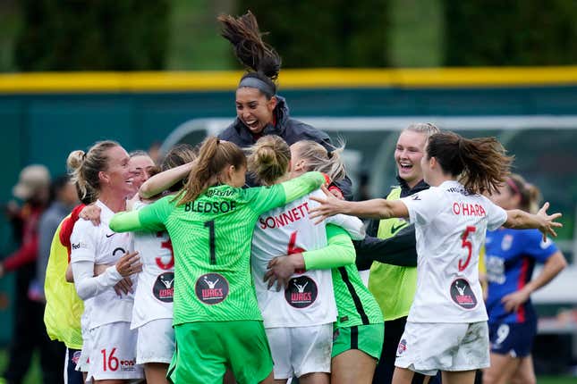 Washington Spirit players celebrate after defeating the OL Reign in the semifinals of the NWSL soccer playoffs Sunday, Nov. 14, 2021, in Tacoma, Wash.