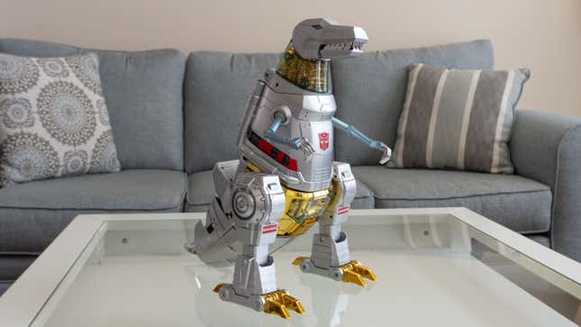 Robosen and Hasbro's Transformers Grimlock Auto-Converting Robot Flagship Collector’s Edition sitting up all on its own in dino mode while powered down.
