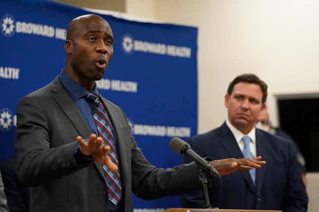 Florida Surgeon Gen. Dr. Joseph A. Ladapo, left, speaks at a news conference with Florida Gov. Ron DeSantis, right, Monday, Jan. 3, 2022, at Broward Health Medical Center in Fort Lauderdale, Fla.
