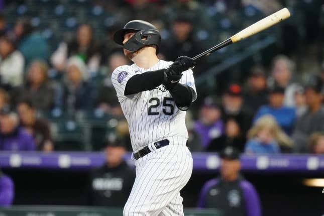 May 12, 2023; Denver, CO, USA; Colorado Rockies first baseman CJ Cron (25) hits an RBI sacrifice fly in the sixth inning against the Philadelphia Phillies at Coors Field.