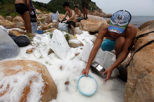 Nurdles show up everywhere. In this photo, volunteers are cleaning nurdles on the coast of Hong Kong’s Lamma island in 2012. Hundreds of millions of the plastic pellets were dumped when containers were knocked off a vessel during a typhoon.