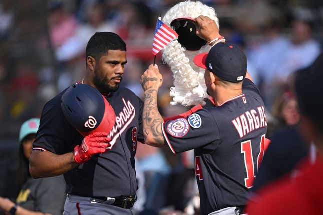 Jun 24, 2023; San Diego, California, USA; Washington Nationals third baseman Jeimer Candelario (9) is greeted at the dugout by shortstop Ildemaro Vargas (14) after hitting a home run against the San Diego Padres during the first inning at Petco Park.