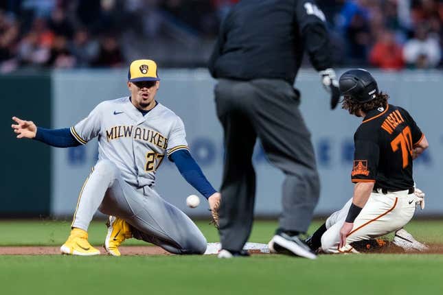 May 5, 2023; San Francisco, California, USA;  San Francisco Giants second baseman Brett Wisely (70) steals second base in front of Milwaukee Brewers shortstop Willy Adames (27) during the second inning at Oracle Park.