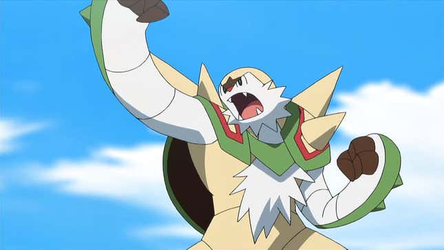 Chesnaught is seen with its fist raised in the air against a blue sky.
