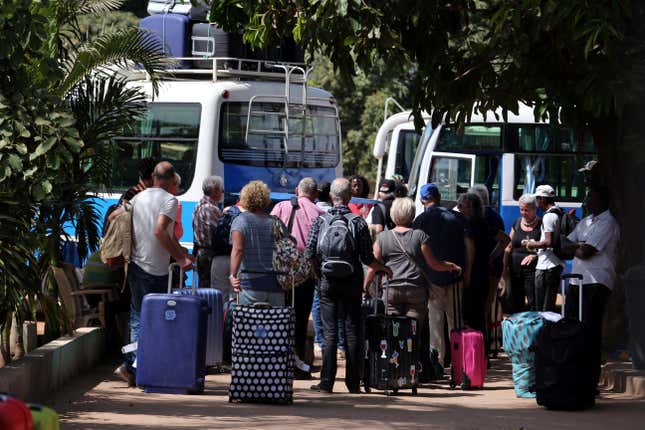 Tourists are seen gathered as they board buses leaving for the airport a day after the country declared a state of emergency, in Banjul, Gambia January 18, 2017.