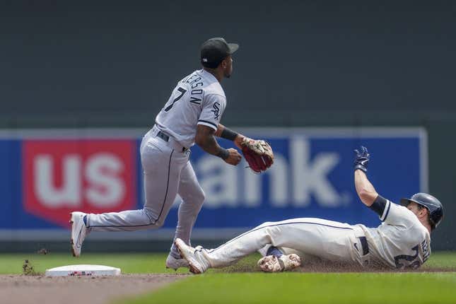 Jul 23, 2023; Minneapolis, Minnesota, USA; Minnesota Twins right fielder Max Kepler (26) doubles as Chicago White Sox shortstop Tim Anderson (7) fields the throw from right in the second inning at Target Field.