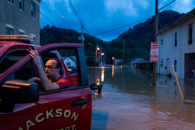 A firefighter with the Jackson Fire Department in front of the flooding in Jackson, Kentucky. 