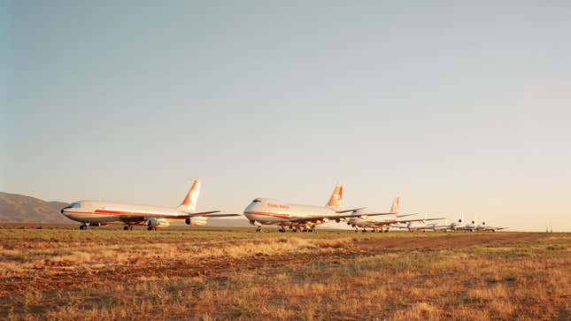 A photo of old jet liners in the desert. 
