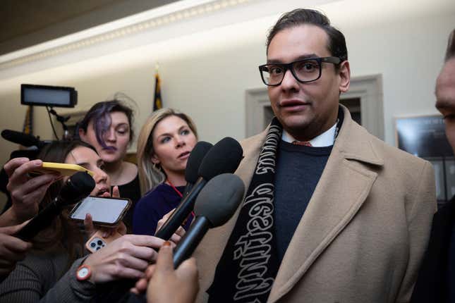 Rep. George Santos (R-N.Y.) speaks with reporters as he departs his office on Capitol Hill Jan. 11, 2023. 