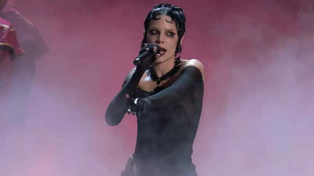 Singer Halsey appears on stage at the Game Awards in a black dress.