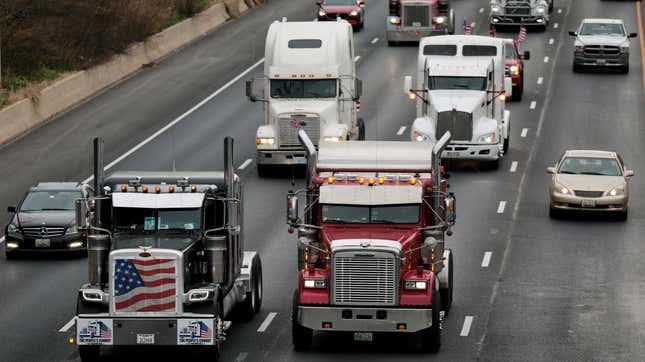 BETHESDA, MARYLAND - MARCH 07: Trucks drive alongside each other as they participate in The Peoples Convoy on the Capitol Beltway on March 07, 2022 in Bethesda, Maryland. 