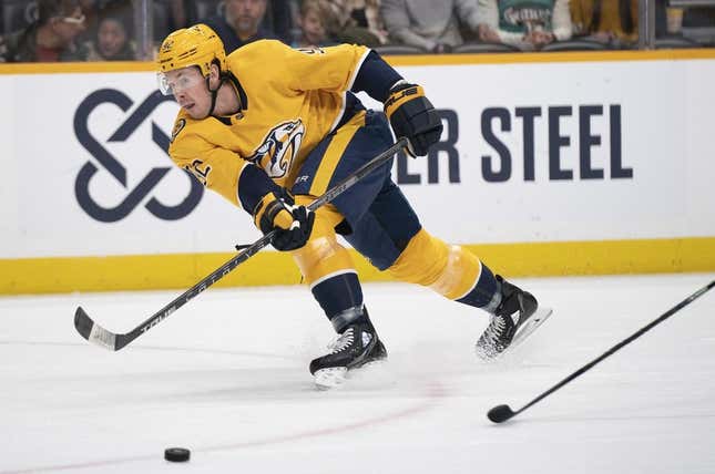 Feb 13, 2023; Nashville, Tennessee USA; Nashville Predators center Ryan Johansen (92) passes the puck across the ice during the first period of the game against the Arizona Coyotes at Bridgestone Arena.