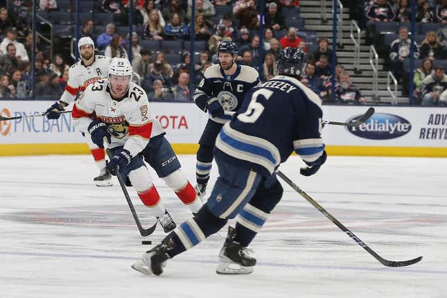 Apr 1, 2023; Columbus, Ohio, USA; Florida Panthers center Carter Verhaeghe (23) controls the puck as Columbus Blue Jackets defenseman Billy Sweezey (6) defends during the third period at Nationwide Arena.