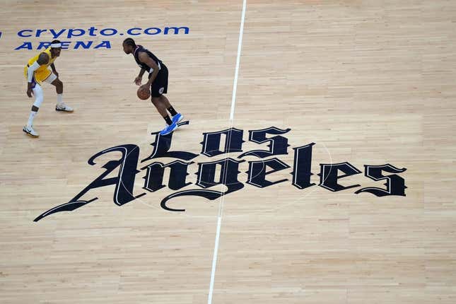 Apr 5, 2023; Los Angeles, California, USA; A general overall view as LA Clippers forward Kawhi Leonard (2) dribbles the ball against Los Angeles Lakers forward Jarred Vanderbilt (2) at midcourt on the Clippers Los Angeles logo in the first half at Crypto.com Arena.