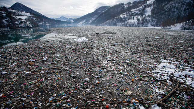 Plastic bottles and other waste float on Potpecko lake in Serbia.