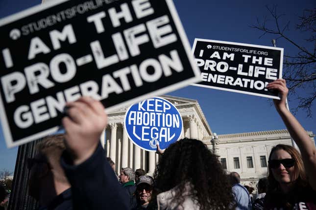 Pro-life activists try to block the sign of a pro-choice activist during the 2018 March for Life January 19, 2018 in Washington, DC. Activists gathered in the nation's capital for the annual event to protest the anniversary of the Supreme Court Roe v. Wade ruling that legalized abortion in 1973.