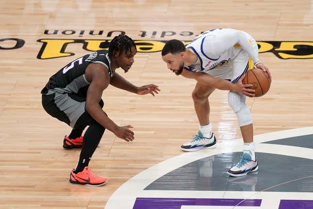 Apr 15, 2023; Sacramento, California, USA; Golden State Warriors guard Stephen Curry (30) holds onto the ball next to Sacramento Kings guard Davion Mitchell (15) in the second quarter during game one of the 2023 NBA playoffs at the Golden 1 Center.