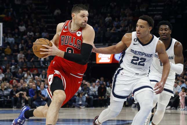 Feb 7, 2023; Memphis, Tennessee, USA; Chicago Bulls center Nikola Vucevic (9) drives to the basket as Memphis Grizzlies guard Desmond Bane (22) defends during the second half at FedExForum.
