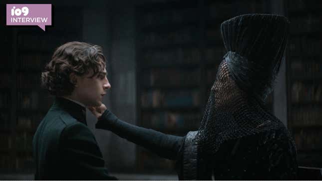Charlotte Rampling's Reverend Mother Mohiam is dressed in all black and reaches out to Timothée Chalamet's Paul Atreides' face in a still from Dune.