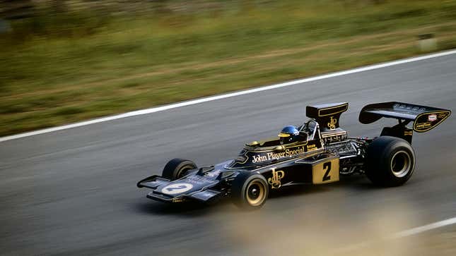 A photo of a black and gold, Ford-powered Lotus F1 car. 