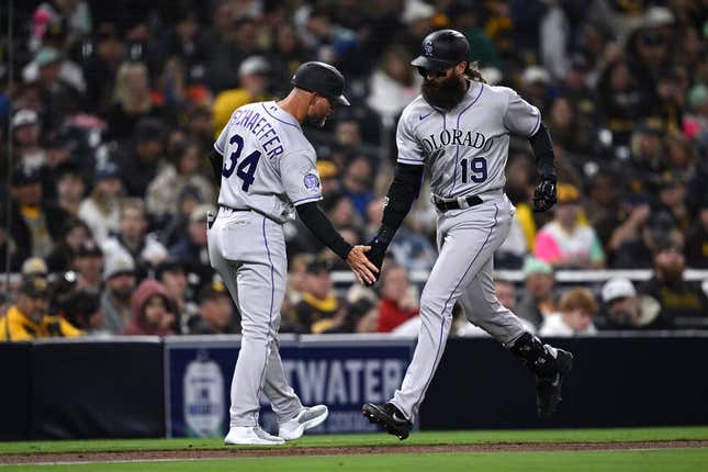 Mar 31, 2023; San Diego, California, USA; Colorado Rockies designated hitter Charlie Blackmon (19) is congratulated by third base coach Warren Schaeffer (34) after hitting a two-run home run during the fifth inning against the San Diego Padresat Petco Park.