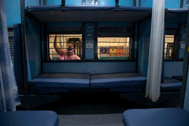 A Railway employee cleaning a coach that has been turned into a self-isolation ward.