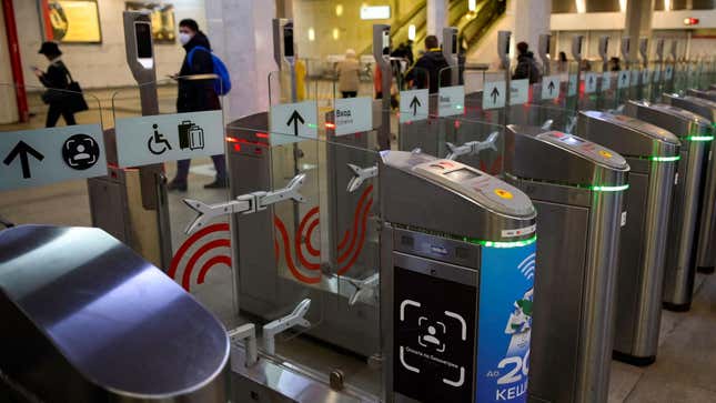 A sign sits on a ticket gate equipped with a facial recognition fare payment system - Face Pay - at Turgenevskaya metro station in Moscow on September 23, 2021.