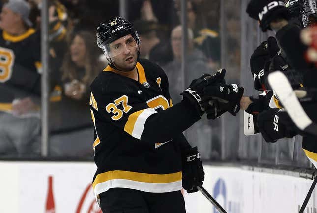 Mar 11, 2023; Boston, Massachusetts, USA; Boston Bruins center Patrice Bergeron (37) is congratulated at the bench after scoring against the Detroit Red Wings during the second period at TD Garden.
