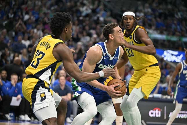 Feb 28, 2023; Dallas, Texas, USA; Dallas Mavericks center Dwight Powell (7) grabs a rebound between Indiana Pacers forward Aaron Nesmith (23) and center Myles Turner (33) during the first quarter at the American Airlines Center.