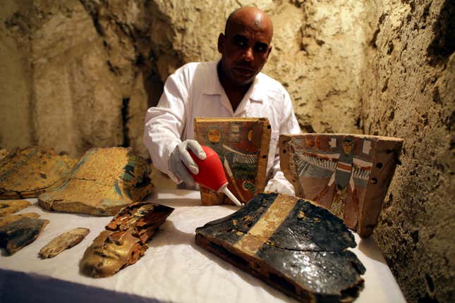 epa06378510 An Egyptian archaeologist works on restoring items at a recently found tomb and re-discovery of an older one, at Draa Abul Naga necropolis on Luxor?s west bank, 700km south of Cairo, Egypt, 09 December 2017. Egypt's Ministry of Antiquities announced the discovery of a tomb from the New Kingdom that belongs to the old Egyptian deity Amun's Goldsmith, Amenemhat (tomb number Kampp 390) and a burial shaft housing the mummy of a lady and her two children. The newly discovered tomb includes an entrance located in the courtyard of another Middle Kingdom tomb number Kampp150. EPA-EFE/KHALED ELFIQI