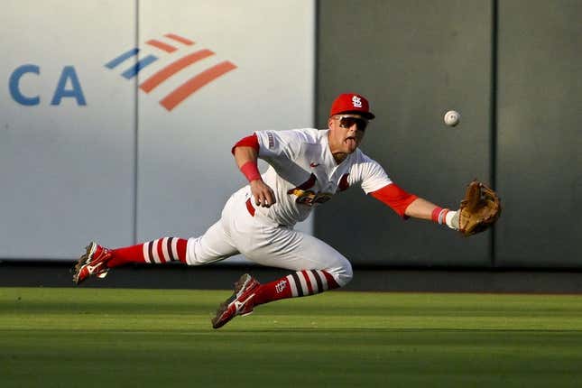 Jul 18, 2023; St. Louis, Missouri, USA;  St. Louis Cardinals center fielder Lars Nootbaar (21) dives and catches a line drive hit by Miami Marlins center fielder Dane Myers (not pictured) during the second inning at Busch Stadium.