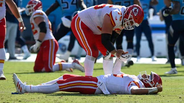 Kansas City Chiefs quarterback Patrick Mahomes is helped up by Mike Remmers after Mahomes was hit in the second half of an NFL football game against the Tennessee Titans.