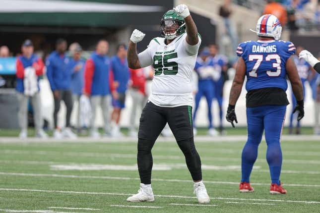 Nov 6, 2022; East Rutherford, New Jersey, USA; New York Jets defensive tackle Quinnen Williams (95) celebrates a defensive stop  being Buffalo Bills offensive tackle Dion Dawkins (73) during the second half at MetLife Stadium.