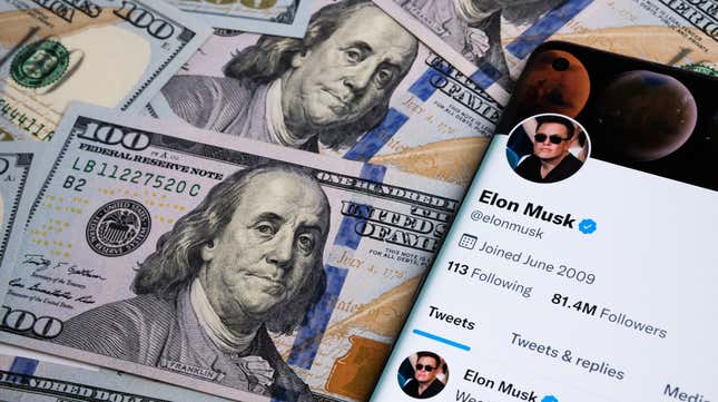 A pile of 100 dollar bills and a smartphone bearing Elon Musk's Twitter page.