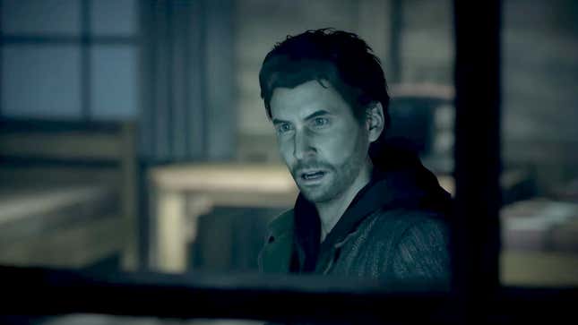 Alan Wake looks out of a window with a look a shock or surprise on his face.