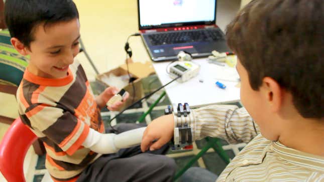 Can children play with other children while using their prosthetic arms? Dario plays with his best friend.