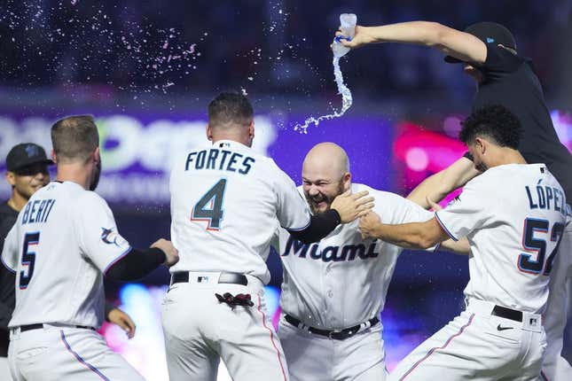 Aug 13, 2023; Miami, Florida, USA; Miami Marlins third baseman Jake Burger (36) celebrates with catcher Nick Fortes (4), relief pitcher Jorge Lopez (52), and shortstop Jon Berti (5) after hitting a walk-off single against the New York Yankees at loanDepot Park.